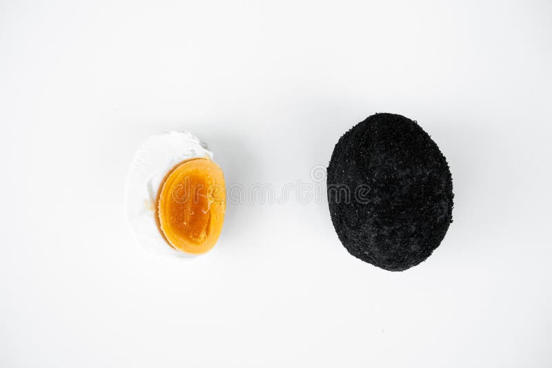 An Old Duck Egg Recipe in Ash. Salty Pickled Duck Egg in Ash on a White Background Stock Photo