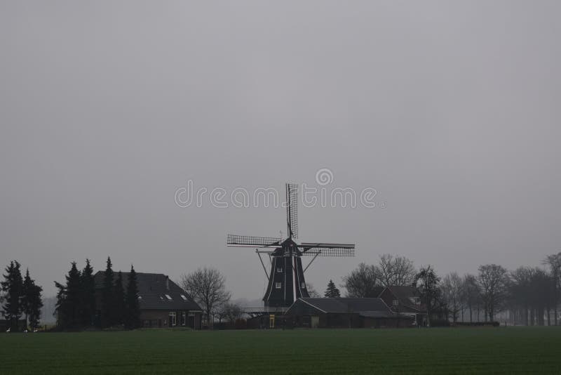 Old Dutch mill in a winter landscape royalty free stock image