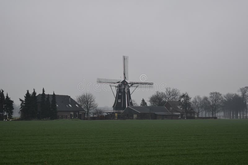 Old Dutch mill in a winter landscape royalty free stock photography