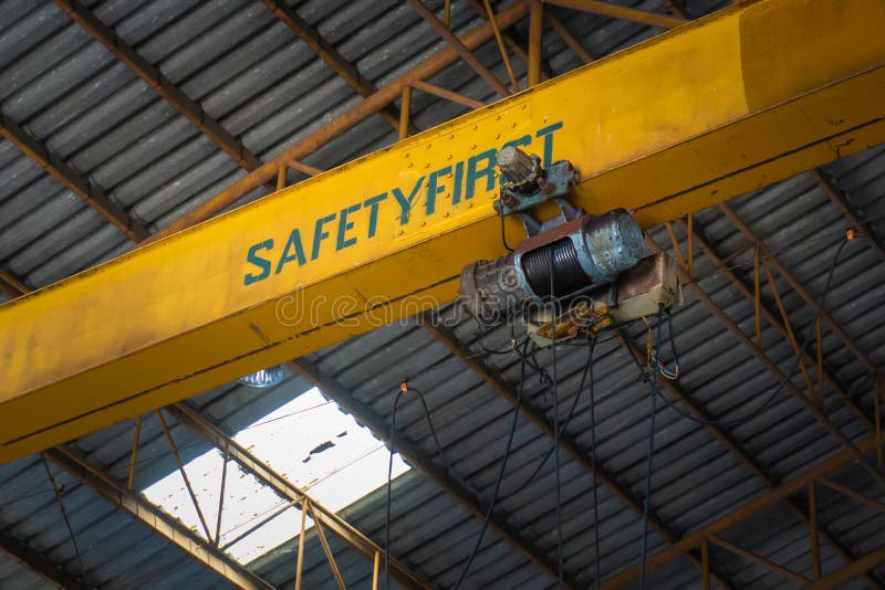 Old Electric Cable Hoist in warehouses or factories and Safety first warning signs