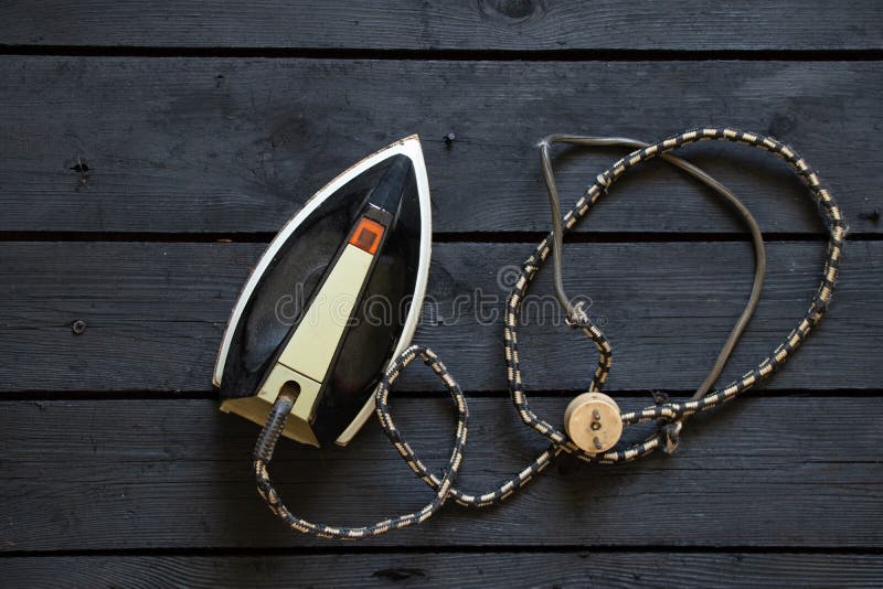 An Old Electric Iron Stands on a Black Wooden Floor Stock Image Image