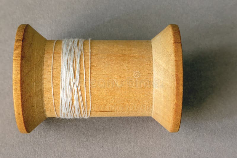 brown thread twisted into a spool on a wooden background 18964722 Stock  Photo at Vecteezy