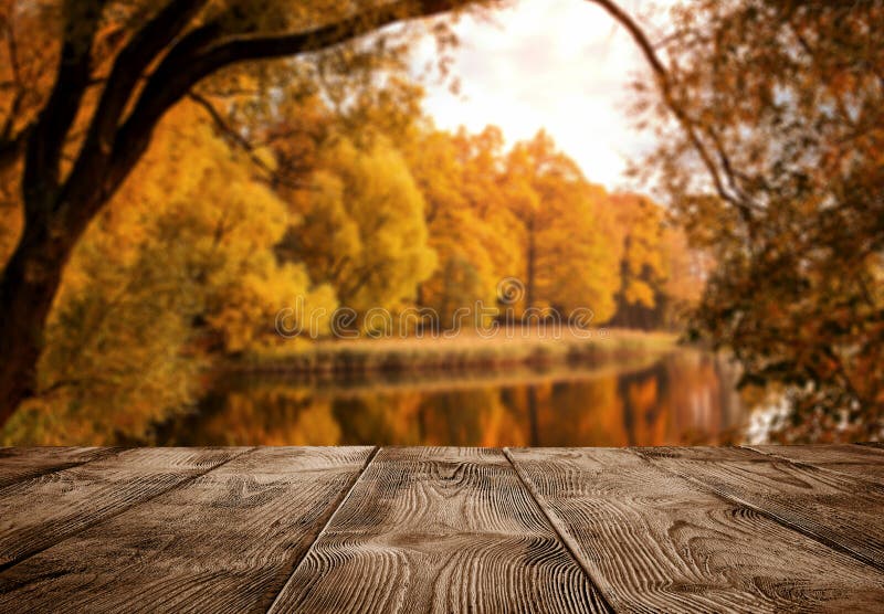 Old empty wooden table over the lake