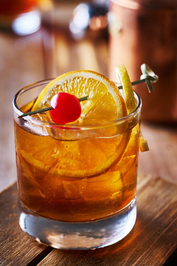 Old Fashioned Cocktail Garnished with Cherry, Orange and Lemon Peel