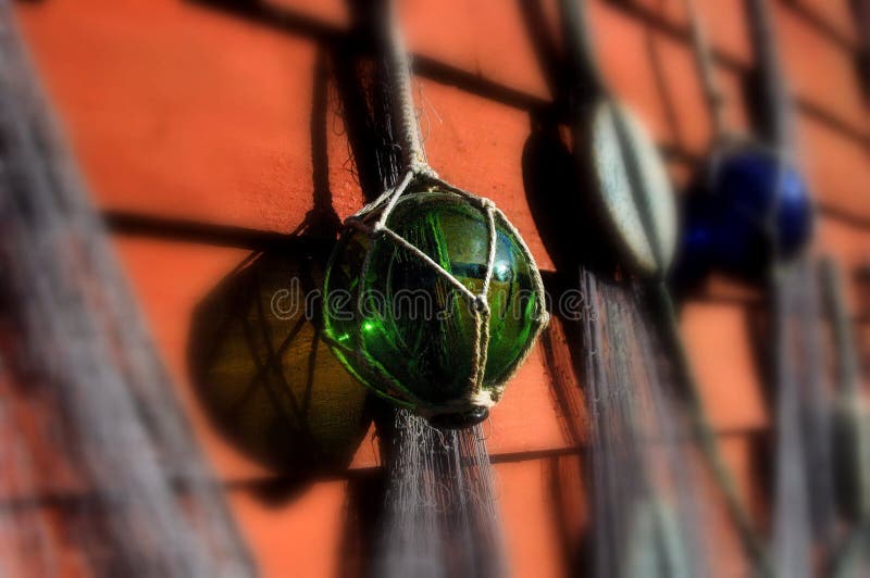 Fishing Net with Colorful Glass Balls and Bobbers Hanging on a Red Wall  Stock Image - Image of fishing, floats: 268536825