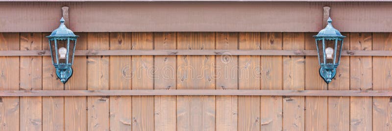 Old fashioned lantern on a brown wooden wall. royalty free stock images