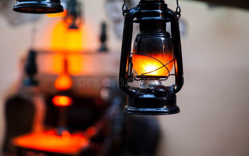 Old fashioned lantern in darkness. Light concept. stock photos