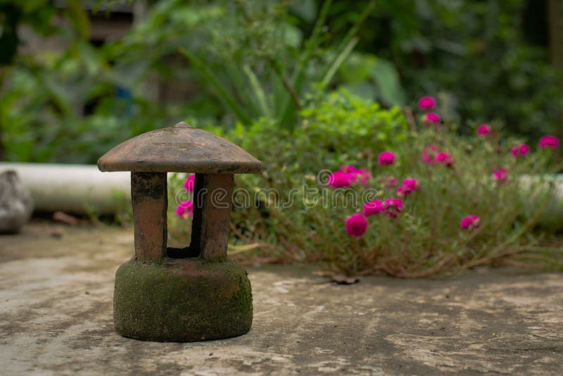 Old fashioned lantern, green garden tub royalty free stock image