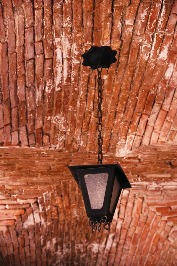 Old fashioned lantern hanging from the wall stock images