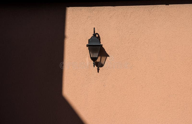 Old fashioned lantern mounted on wall royalty free stock photo