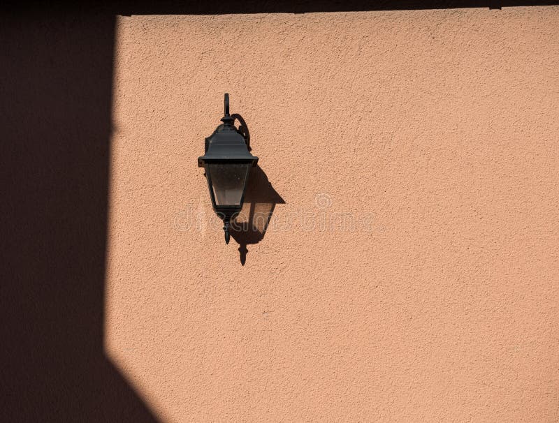 Old fashioned lantern mounted on wall stock photos