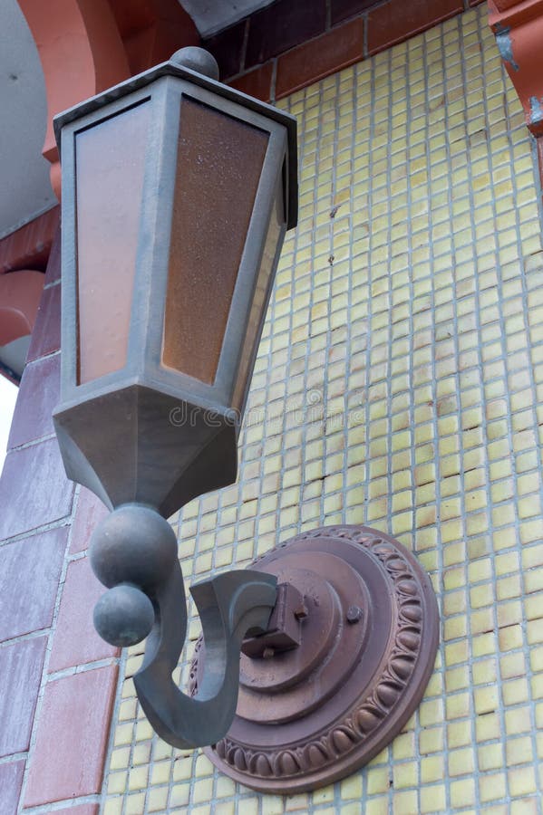 Old fashioned lantern on a tiled wall stock photography