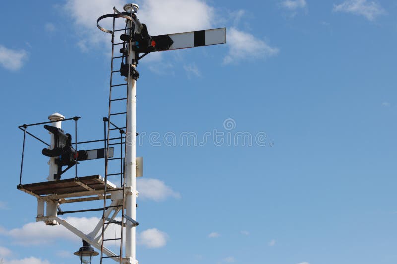 Old-fashioned mechanical railway signal and blue sky background stock photo