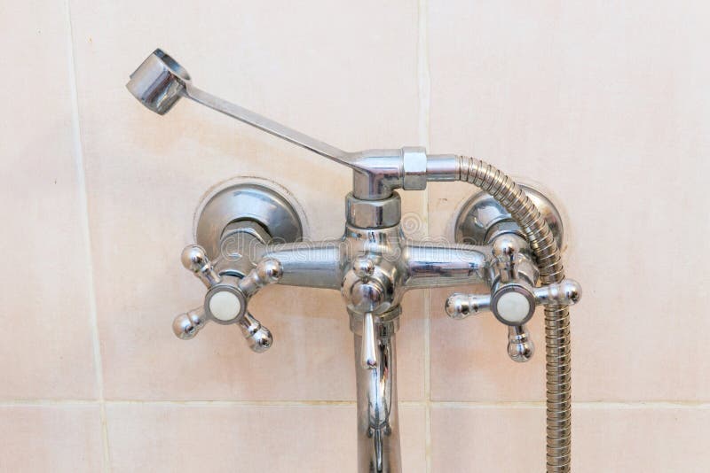 Old faucet the faucet Assembly in the bathroom. Limescale on chrome taps and mixer shower stock image