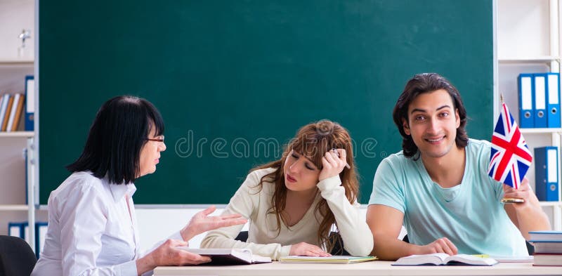 Old female english teacher and students in the classroom stock photos