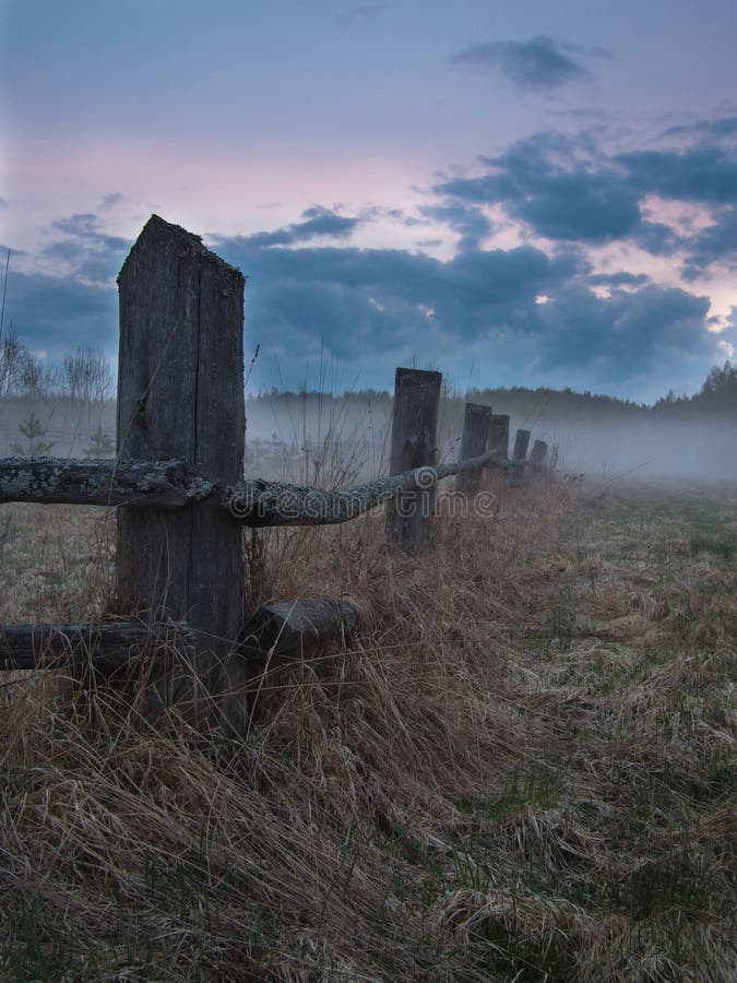 Old fence in the fog