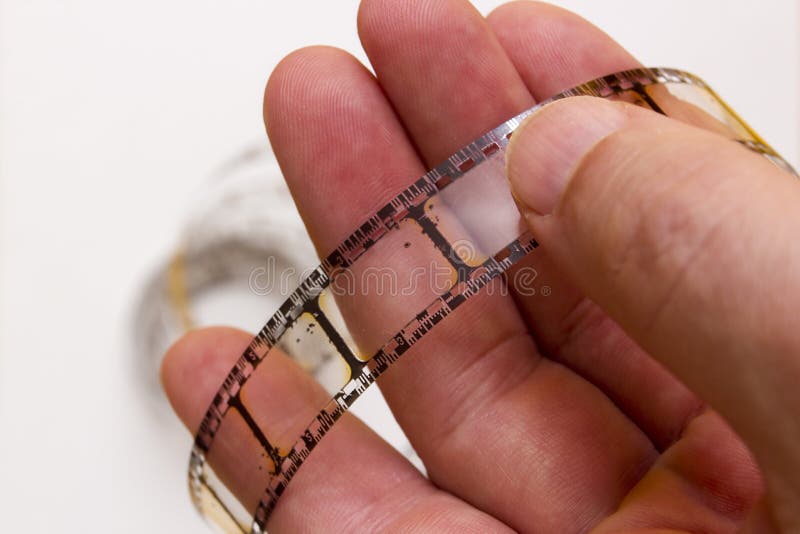 Old film strip in the man s hand