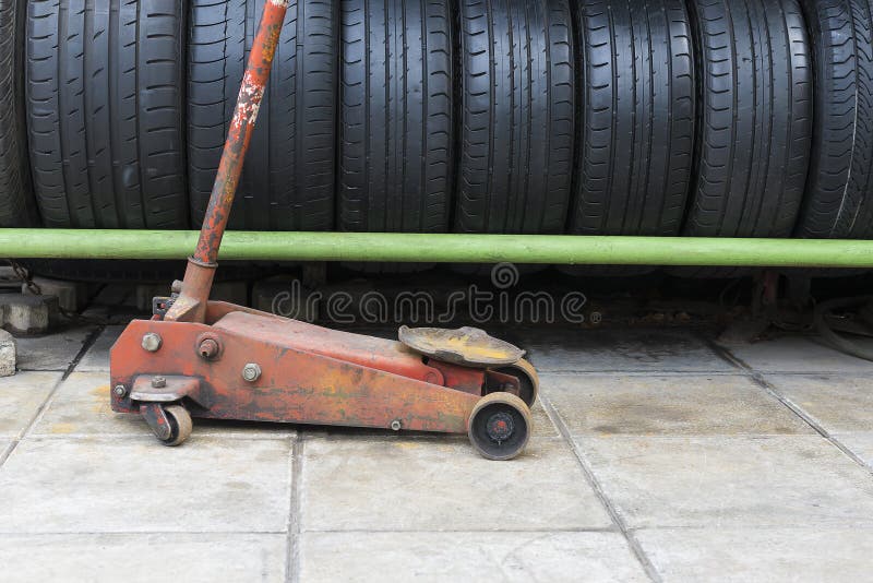 The old floor jack with the car used tire stack