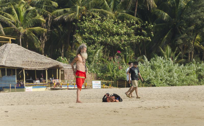 An old foreign tourist standing in yogi attire on the sand beach royalty free stock photo An old foreign tourist standing in yogi attire on the sand beach royalty free stock photo