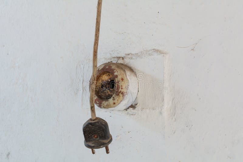 Old fork and socket on the wall