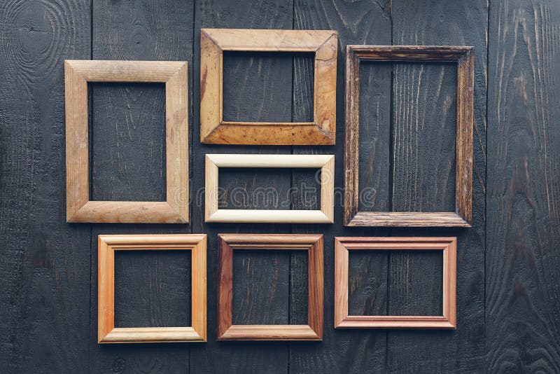 Old frames on wooden wall stock image. Image of wooden 164247401