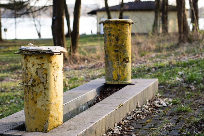 An Old Garbage Bin. Waste Trash Cans Set in a Park between Trees Stock