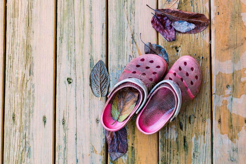 Old garden shoes on wooden deck floor. royalty free stock images Old garden shoes on wooden deck floor. royalty free stock images