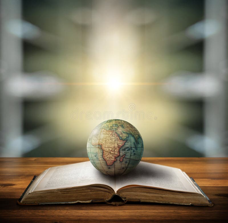 An old globe lying on an open book against the background of library. Selective focus. Retro style. Science, education, travel