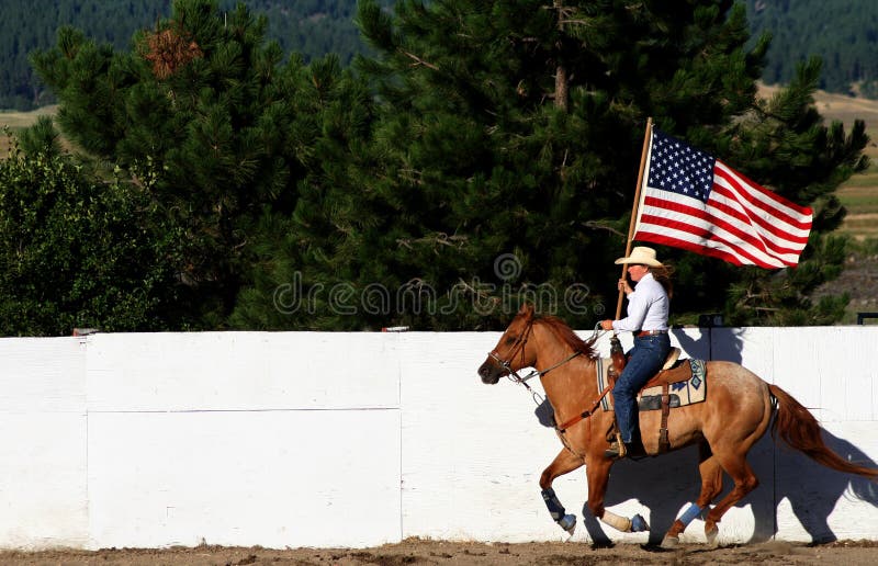 Rider displays U.S. flag at rodeo in Idaho, Valley County Fair and Rodeo. Rider displays U.S. flag at rodeo in Idaho, Valley County Fair and Rodeo