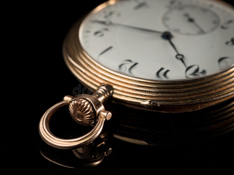 https://thumbs.dreamstime.com/b/old-golden-pocket-watch-black-reflective-surface-detail-used-120412563.jpg