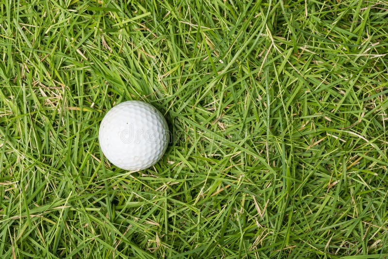 Old golf ball on green grass texture background. Day game drive stock images, royalty-free photos and pictures