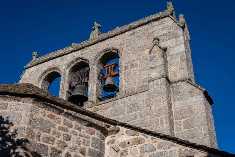 Old granite bell tower against blue sky ,fau de peyre ,lozere , france