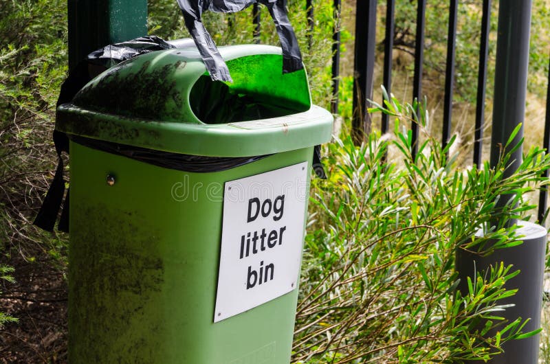 Old green Dog litter bin in a public park. stock image Old green Dog litter bin in a public park. stock image