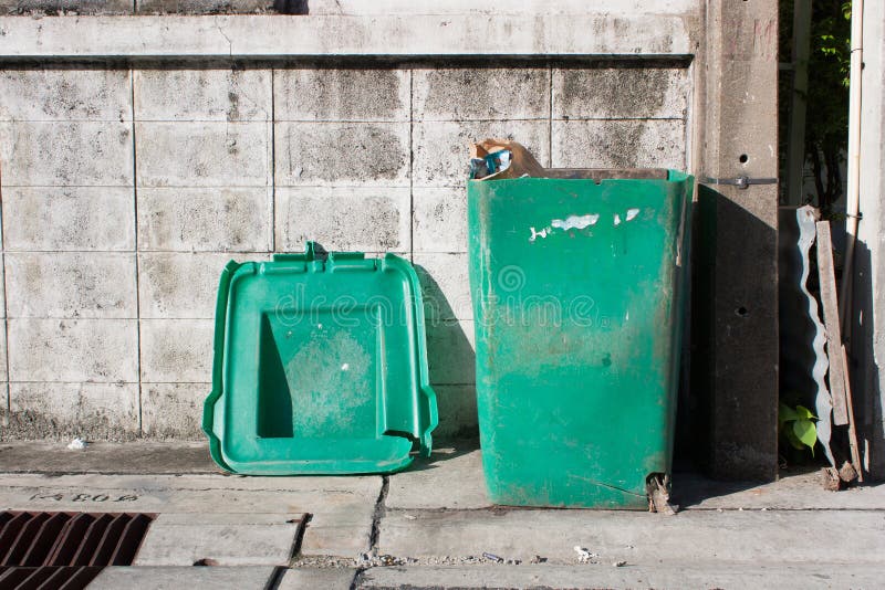 Old green trashcan stock photography