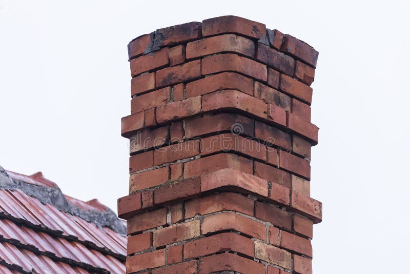 Old hand-made chimney on the house