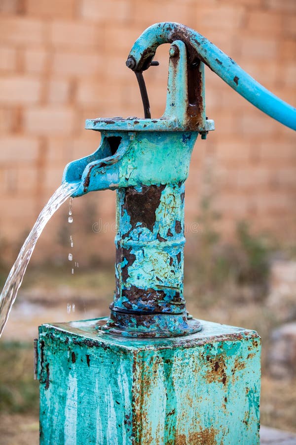 Old fashion outdoor well hand water pump Stock Photo - Alamy