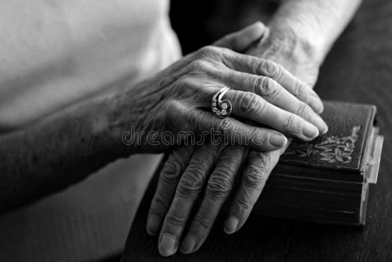 Old Woman's Hands on Her Bible Wearing Her Vintage Ring. Old Woman's Hands on Her Bible Wearing Her Vintage Ring