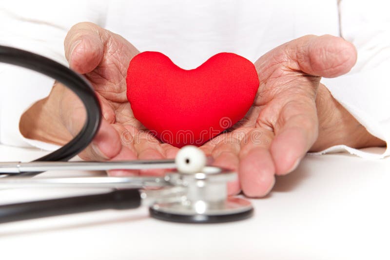 Old hands of the elderly giving a red heart