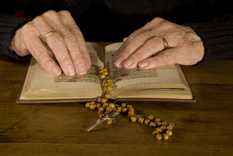 A pair of old hands while reading the old bible. A pair of old hands while reading the old bible