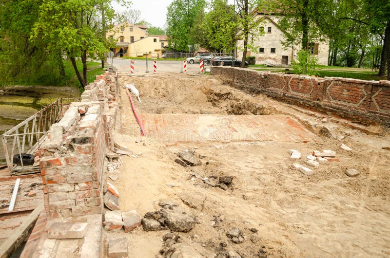 Old, historical red brick bridge repair in summer day. Kuldiga, Latvia stock photos