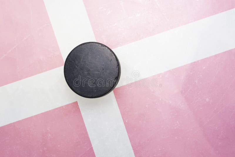 Old hockey puck is on the ice with denmark flag royalty free stock photos Old hockey puck is on the ice with denmark flag royalty free stock photos