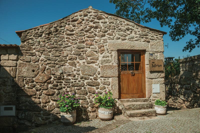 Old house with stone wall and wooden door