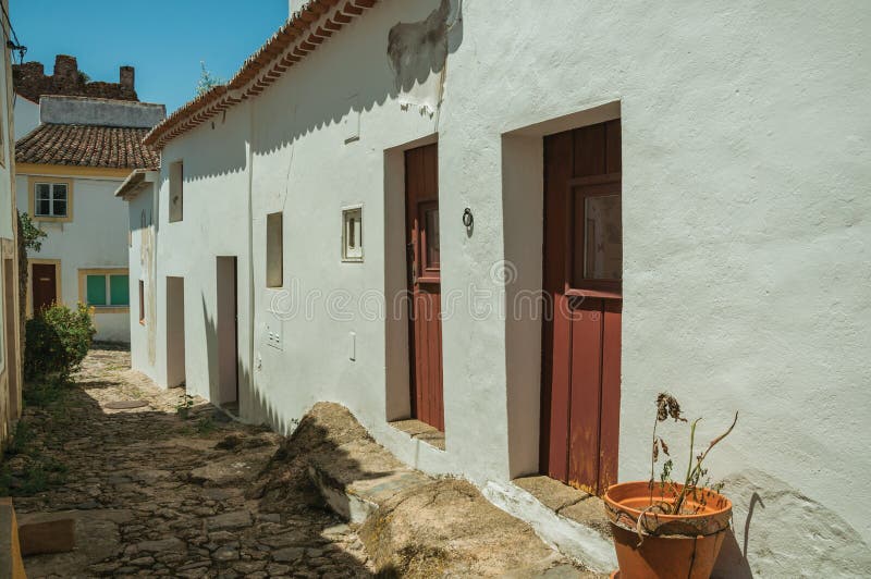 Old houses with whitewashed wall and wooden door