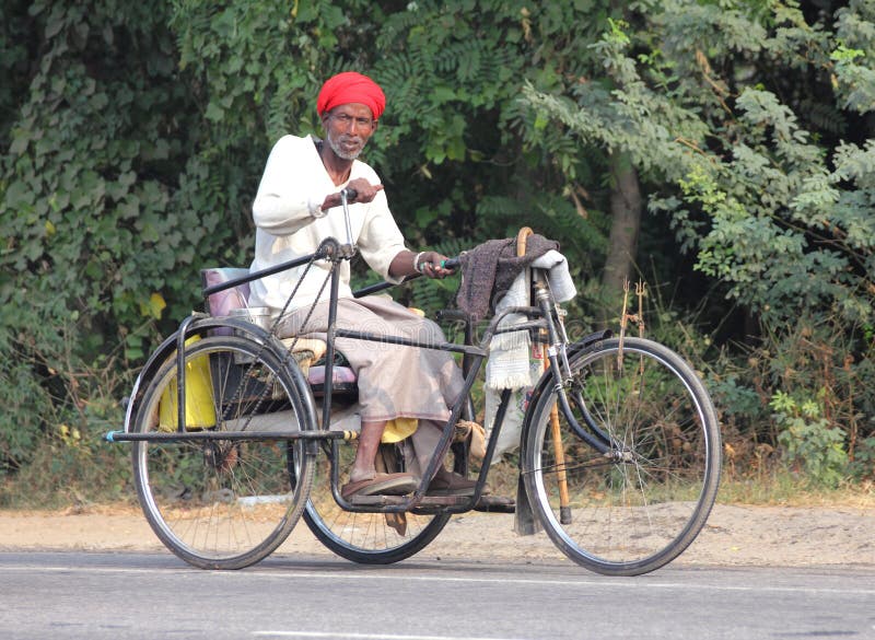 Old indian man on bike with manual drive