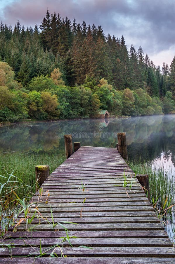 The old wooden jetty and boathouse on Loch Ard in the Scottish highlands. The old wooden jetty and boathouse on Loch Ard in the Scottish highlands