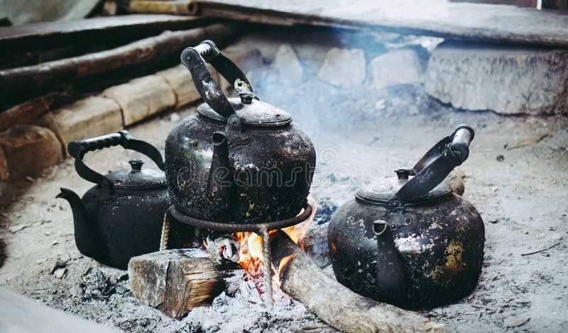 Camp fire and the black kettle of coffee