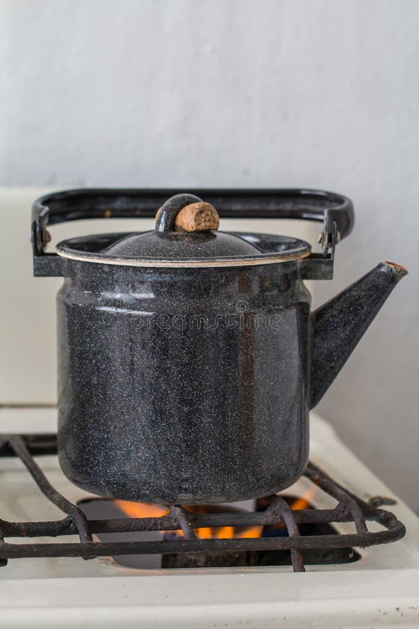 Old kettle on a gas stove stock photo. Image of illuminated 53781186