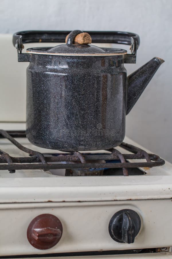 Old kettle on a gas stove stock image. Image of equipment 56302471