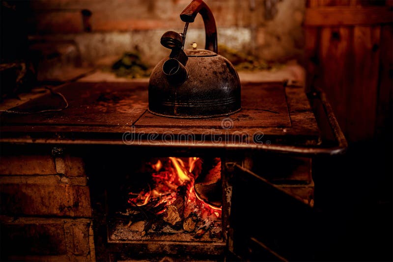 Old kettle on stove and opening fire