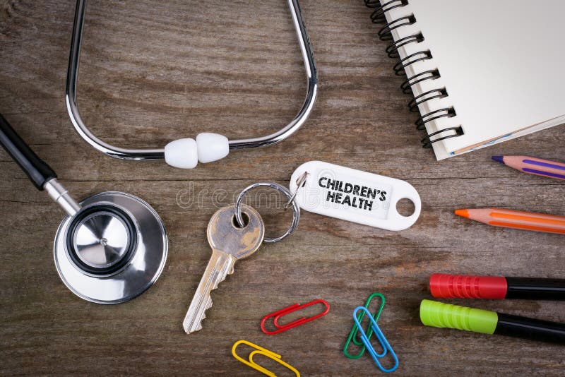 Old key With children s health Text. Wooden texture background w